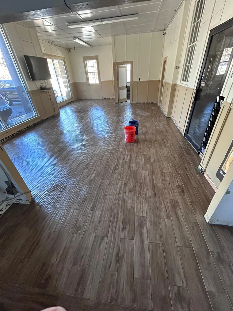 Wood look plank flooring installed across a large open room
